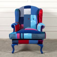 an upholstered blue and red chair with patchwork