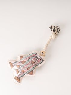 an animal toothbrush with a fish design on it's head and a rope attached to the handle