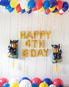 balloons and streamers are hanging from the ceiling in front of a happy 4th birthday backdrop