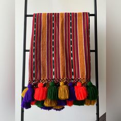 a towel hanging on a ladder with tassels