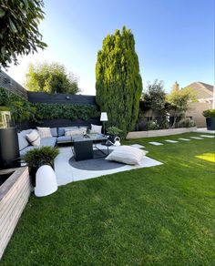 an outdoor living area with grass and furniture