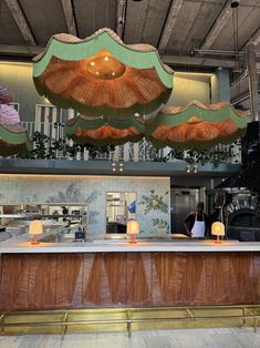 an open kitchen with lots of lights hanging from the ceiling and wood paneling on the walls