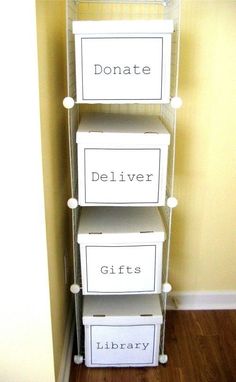 three white boxes are stacked on top of each other in front of a wall with the words donation written on them