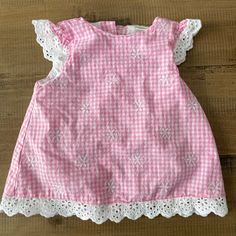 Gingham Style Baby Tunic. Never Worn, Just Dropped The Tags Off In Excitement! Let Me Know If You Want To Add This To Your 3 For $25 Bundle. I Will Adjust The Price! Sleeveless Pink Top For Picnic, Short Sleeve Ruffled Tops For Picnic, Ruffled Short Sleeve Tops For Picnic, Cute Ruffled Tops For Picnic, Pink Cotton Top For Picnic, White Ruffled Top For Picnic, Pink Cotton Tops For Picnic, Cute Cotton Plaid Tops, White Short Sleeve Top For Picnic