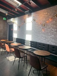 an empty restaurant with wooden tables and chairs