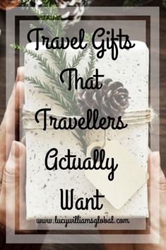 a person holding a gift with pine cones on it and the words travel gifts that travelers actually want