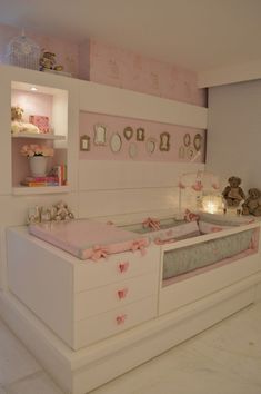 a baby's room is decorated in pink and white