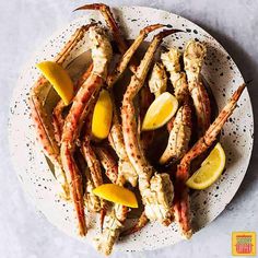 crab legs with lemon wedges on a plate