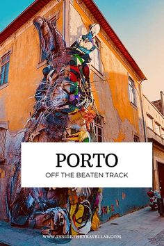 a large rabbit painted on the side of a building with text overlay that reads porto off the beaten track