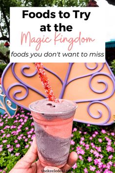 a person holding up a drink with the words foods to try at the magic kingdom