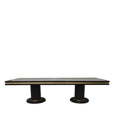 a black and gold dining table with two pedestals on each side, against a white background