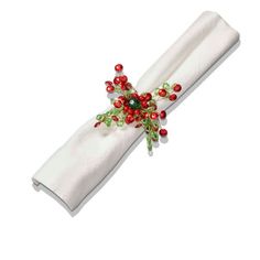 a white napkin with red, green and gold decorations on it's edge is shown