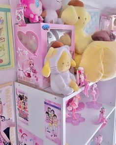 there are many stuffed animals on top of the shelves in this room and one is pink