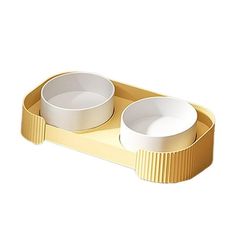 two white bowls sitting on top of a gold tray