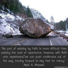 a large rock sitting on the side of a road