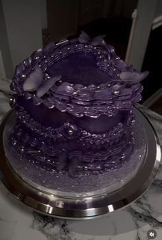 a purple cake sitting on top of a table