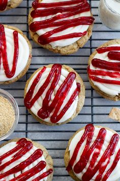 cookies with red and white icing on a cooling rack