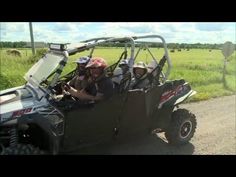 two people in a four passenger vehicle on a dirt road