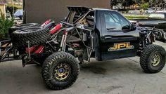 an off road vehicle parked in front of a building