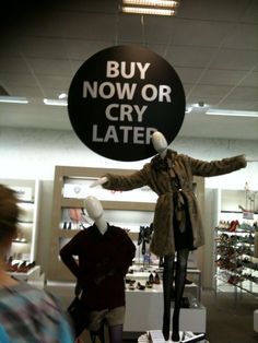 two mannequins in front of a sign that says buy now or cry later