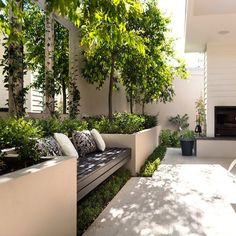 an outdoor living area with white furniture and trees