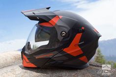 a motorcycle helmet sitting on top of a rock