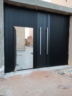 an open garage door on the side of a building that is being constructed with metal slats