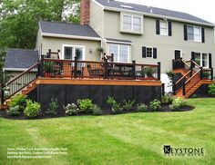 a large house with a deck in the front yard