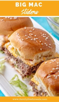 three hamburger sliders with cheese and lettuce on a white plate next to salad