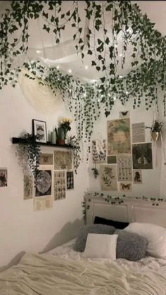 a bedroom with hanging plants and pictures on the wall