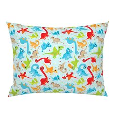 a blue pillow with colorful dinosaurs on it