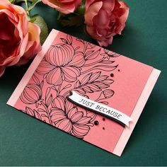 a pink card with flowers and a name tag