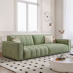 a green couch sitting on top of a white rug in a living room next to a window