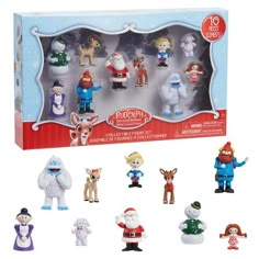 an assortment of toy figurines in a box with snowman and reindeer figures