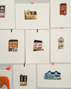 several different colored houses are displayed on white paper