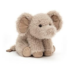 an elephant stuffed animal sitting up against a white background