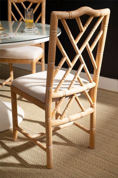 a glass table with two chairs next to it and a white rug on the floor