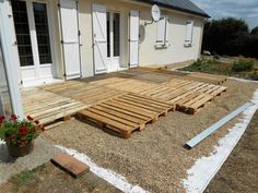 a house with wooden pallets on the ground