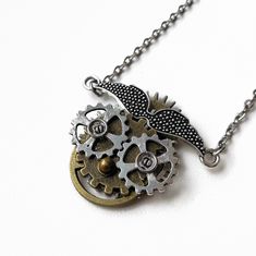 "This steampunk inspired pendant shows a clown with teeth. It looks scary and terrifying. The pendant was made from a scratch with different metal findings and various vintage gears. It's unisex and will be a good choice either for a man or a woman who loves steampunk casual style. Pendant's width is about - 1.5 in (4 cm) Pendant's height is about - 1.4 in (3.5 cm) It comes with a silver-tone chain in a choice of lengths (16\", 18\", 20\", 22\", 24\" or 26\") Chain extension is about 2 in (5 cm)  CARE No special care is required. Do not drop or wet. Do not allow your children to play with jewelry. Avoid chemical exposure including perfumery. The item sells in a beautiful gift box and it can be a perfect gift.  If you need a custom order please let me know and I will try to do my best to pr Steampunk Metal Necklace With Adjustable Chain, Steampunk Style Metal Necklace With Adjustable Chain, Steampunk Necklace With Adjustable Metal Chain, Halloween Steampunk Metal Jewelry, Steampunk Clown, Clown Necklace, Steampunk Casual, Horror Clown, Scary Clown