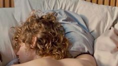 a man laying in bed with his head on the pillow