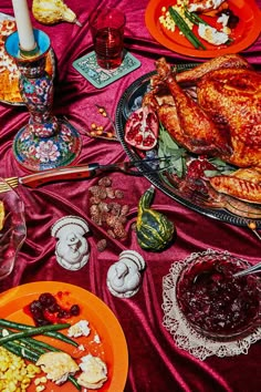 a table topped with plates of food and turkey