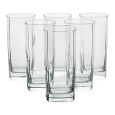 four clear glass vases sitting next to each other