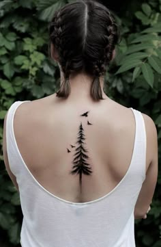 a woman with a tree tattoo on her back