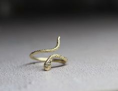 9k solid gold adjustable snake ring , made from recycled gold. Delicate and unique , The ring has been made in wax and then casted in 9k solid gold. Also available with Ruby gemstone : https://cyklu.etsy.com/listing/1575385029 MATERIAL- 9k gold Every piece you purchase from Cyklu is unique and handmade with love and affection, please allow one week after payment  ELSEWHERE - Instagram: instagram.com/CYKLU_JEWELRY -Pinterest: pinterest.com/Cyclu -Twitter: twitter.com/Cyklu - Facebook: Facebook.com/CykluJewelry