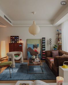 a living room filled with furniture and a painting on the wall