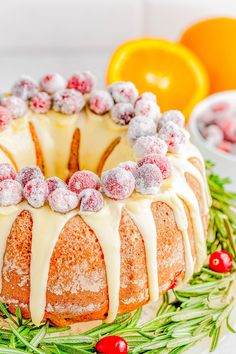 a bundt cake with icing and cranberries on top