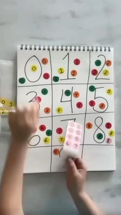 a child is playing with a game on the table and it looks like they are doing something