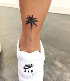 a small palm tree tattoo on the ankle