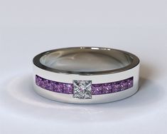 a wedding ring with purple stones and a princess cut diamond set in the center, on a white background