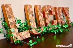 a wooden sign that is sitting on top of a table next to some green leaves